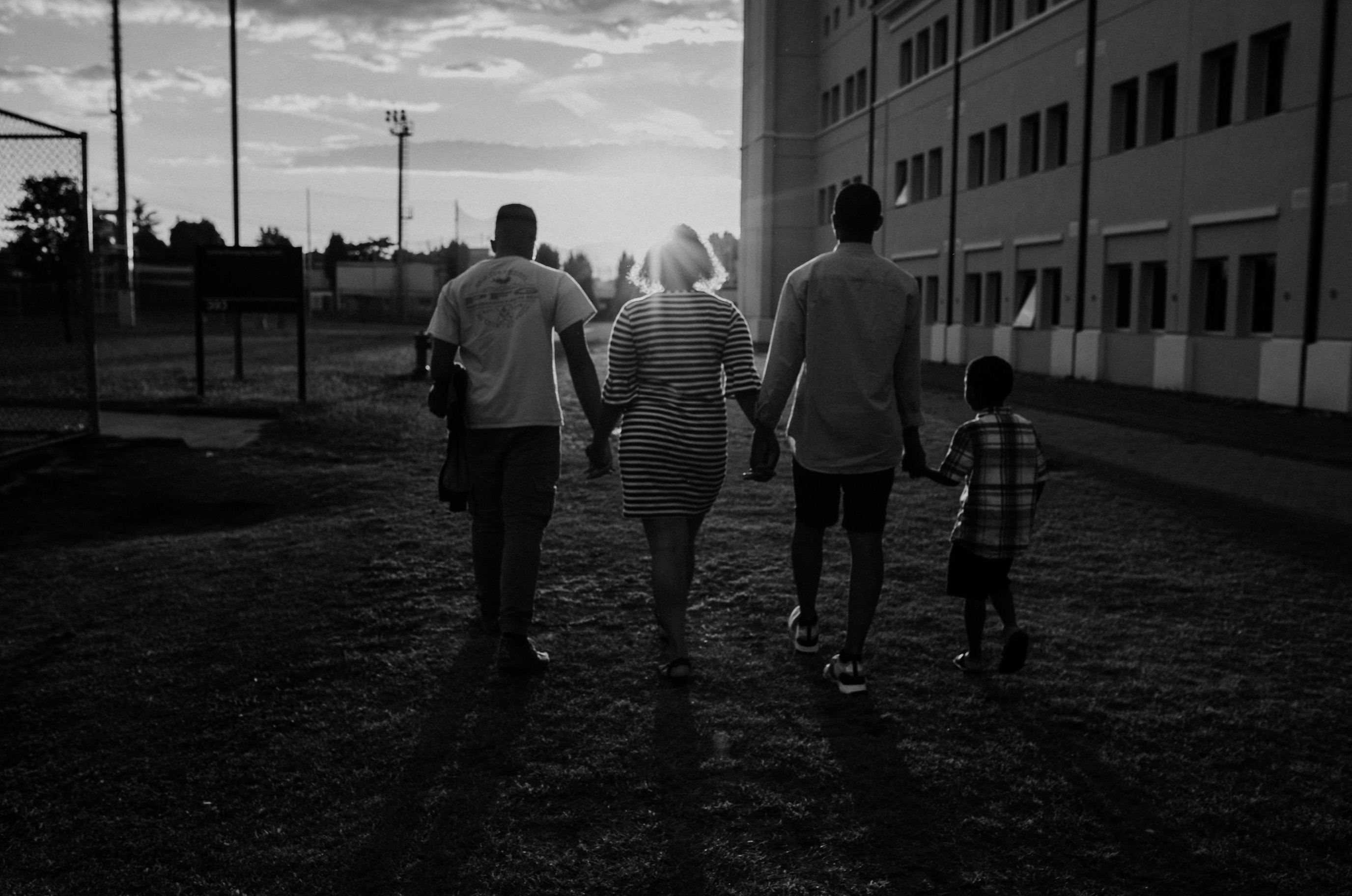 A family walking together in the evening light.